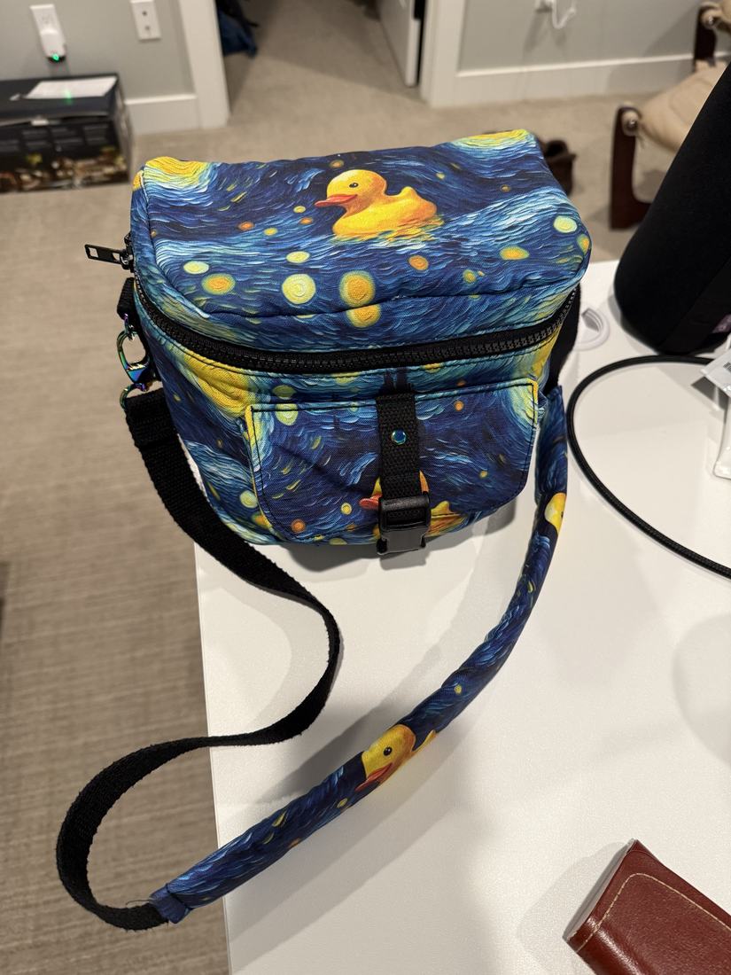 The finished camera bag closed, in a blue Starry Night print with yellow ducks.