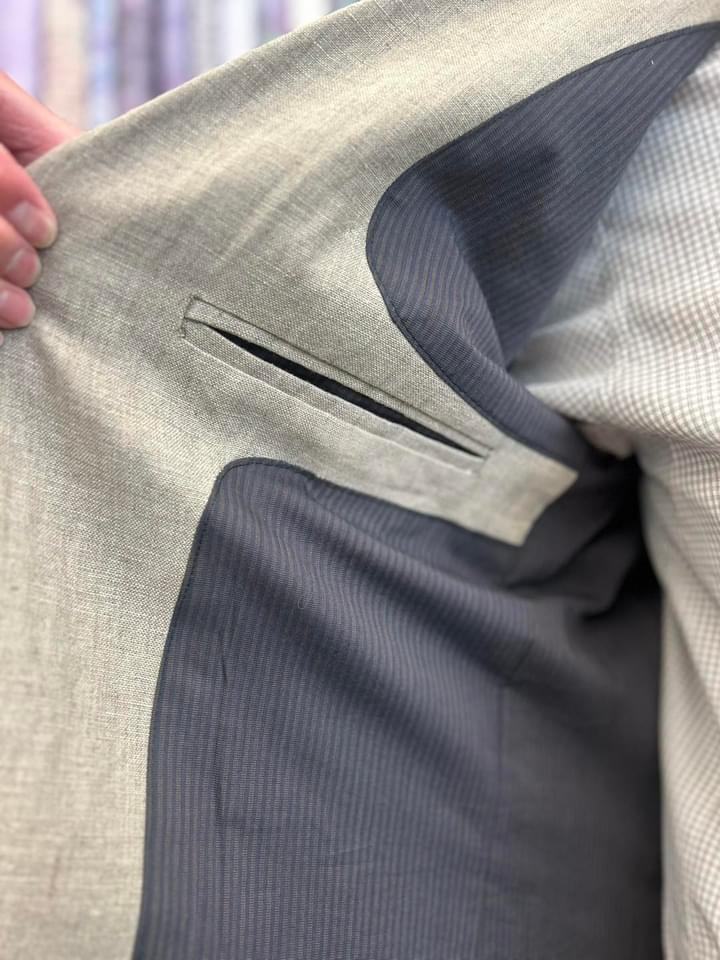 The jacket opened to show a welted inside pocket beside the striped cotton lining.