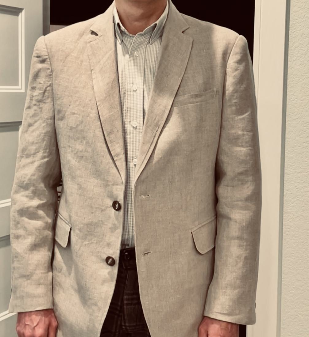 The same linen jacket worn in a hallway under warmer light.