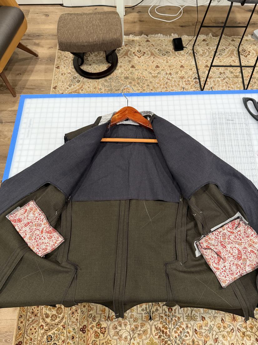 The jacket opened flat showing the installed lining and paisley pocket bags.