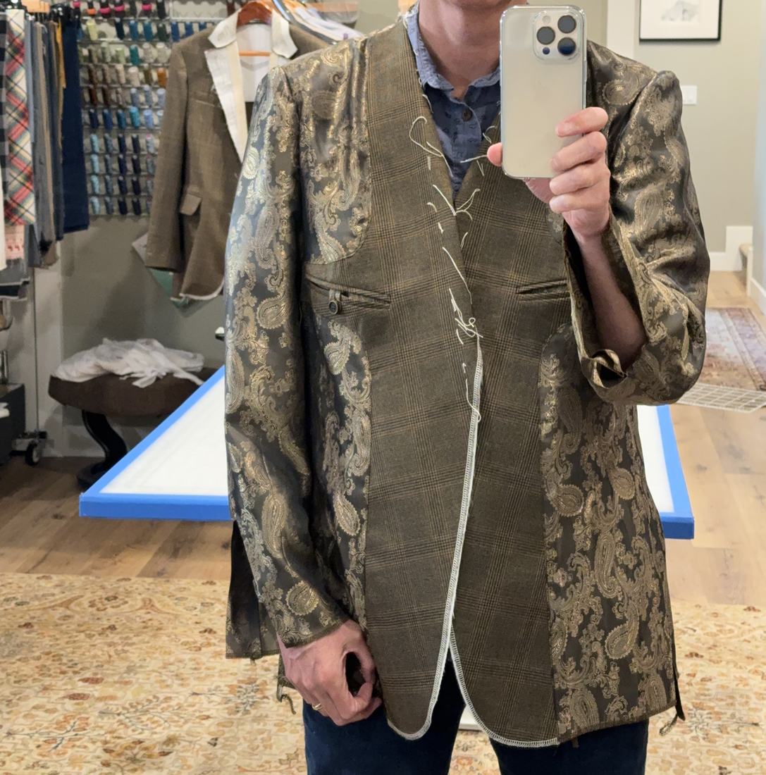 The brocade lining worn as a fitting, basted at the front edge.