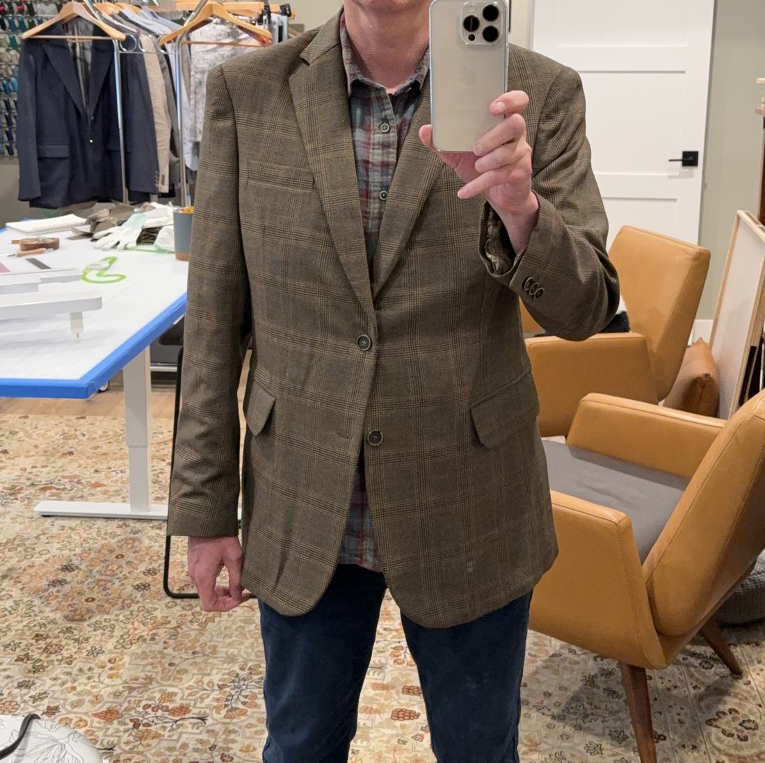 The finished glen plaid jacket worn buttoned over a plaid flannel shirt and jeans.